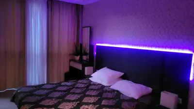 a purple bedroom with a bed with white pillows at Palma Beach in Harmony Suites 2,3 in Sunny Beach