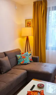 a living room with a brown couch and a window at Morava 1 Asparuhovo Beach Holiday House in Varna City