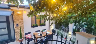 a patio with a table and chairs on a balcony at Morava 1 Asparuhovo Beach Holiday House in Varna City
