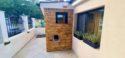 a brick wall next to a building with plants at Morava 1 Asparuhovo Beach Holiday House in Varna City