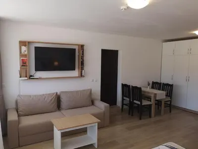 a living room with a couch and a table at South Beach Apartment in Nesebar