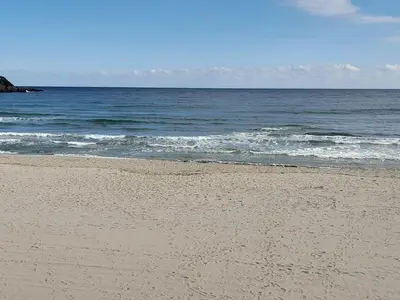 a sandy beach with the ocean in the background at Трёхкомнатные роскошные апартаменты у моря в Санта Марина in Sozopol