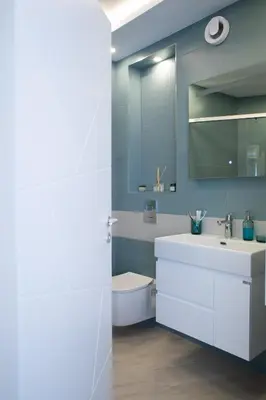 a bathroom with a white sink and a mirror at Sea Bliss in Burgas City