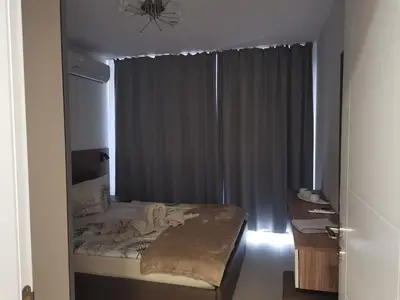 a small bedroom with a bed with a window at Polarstar Beach Bulgarien Sveti Vlas in Sveti Vlas
