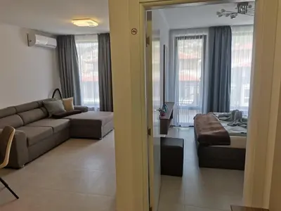 a living room with a couch and a room with a bed at Polarstar Beach Bulgarien Sveti Vlas in Sveti Vlas