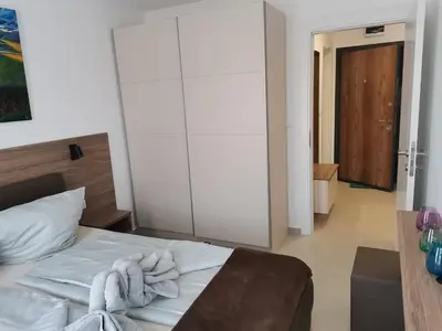 a bedroom with a bed with a towel on it at Polarstar Beach Bulgarien Sveti Vlas in Sveti Vlas