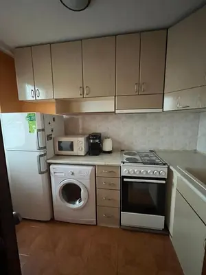 a kitchen with a white refrigerator and a washer and dryer at Apartment Geni in Pomorie