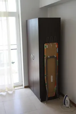 a room with a locker and a suitcase next to a door at Grand Kamelia Apartment in Sunny Beach