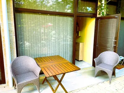 a wooden table and two chairs on a porch at Stamopolu Lux ground floor in Primorsko