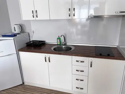 a kitchen with white cabinets and a sink at Stamopolu Lux ground floor in Primorsko