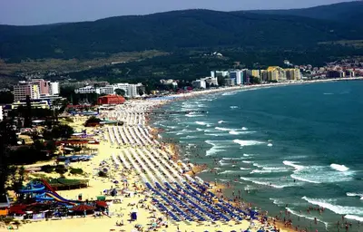 a beach with a lot of people and the ocean at Harmony Suites-1 Private Apartment 42А in Sunny Beach