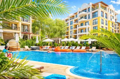 a pool at a hotel with chairs and umbrellas at Harmony Suites-1 Private Apartment 42А in Sunny Beach
