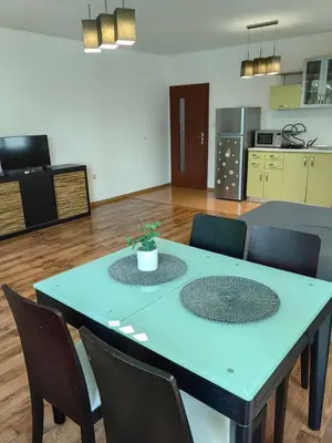 a blue table and chairs in a room with a kitchen at Уютно студио в Поморие Мари in Pomorie