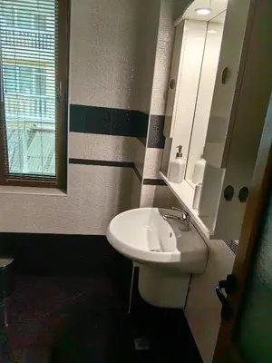 a bathroom with a sink and a mirror at Уютно студио в Поморие Мари in Pomorie