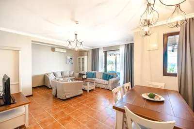 a living room with a table and a dining room at LUXURY APARTMENT Sozopolis in Sozopol