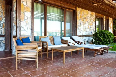 a group of chairs and tables on a patio at LUXURY APARTMENT Sozopolis in Sozopol