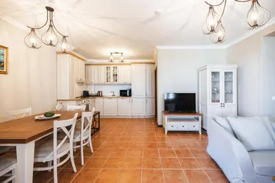 a kitchen and living room with a table and a couch at LUXURY APARTMENT Sozopolis in Sozopol