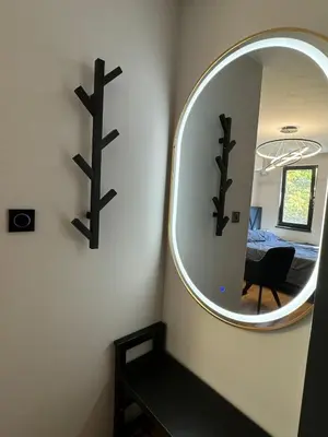 a mirror on a wall in a room at Room de Port in Burgas City