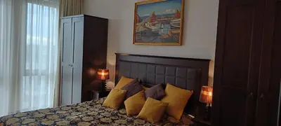 a bedroom with a bed with yellow and purple pillows at Barcelo Royal Beach in Sunny Beach