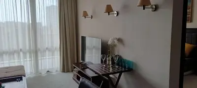 a living room with a table with a tv and a couch at Barcelo Royal Beach in Sunny Beach