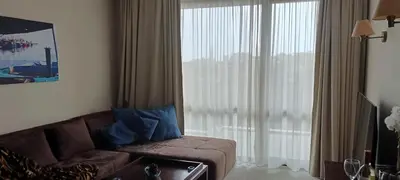 a living room with a couch and a large window at Barcelo Royal Beach in Sunny Beach