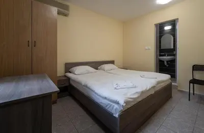 a bedroom with a large bed and a sink at Citybox - Shipka in Varna City