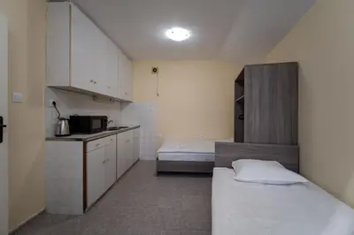 a small room with a kitchen and a bed in it at Citybox - Shipka in Varna City