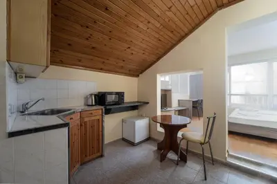 a kitchen with a sink and a table in a room at Citybox - Shipka in Varna City