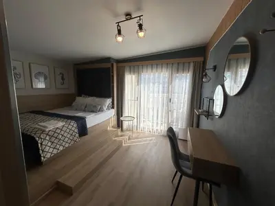 a bedroom with a bed and a table and a desk at Wavehaven Apartment at South Bay in Varna City