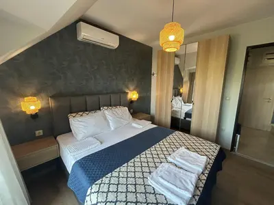 a bedroom with a bed with two towels on it at Wavehaven Apartment at South Bay in Varna City
