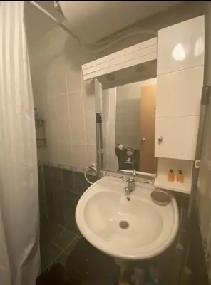 a bathroom with a white sink and a mirror at Spacious Modern Two-Bedroon Suite in Elit 1 Complex in Sunny Beach