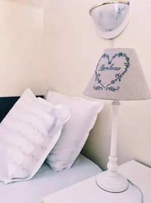 a lamp on a table next to a bed with pillows at Spacious Modern Two-Bedroon Suite in Elit 1 Complex in Sunny Beach