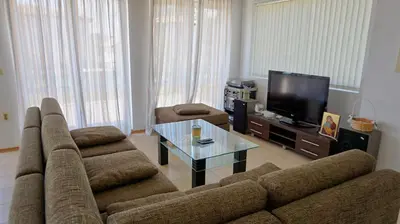 a living room with a couch and a tv at вила Мариела - villa Mariela in Yunets