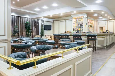 a barber shop with a bunch of chairs and tables at Tiara Beach - All Inclusive in Sunny Beach