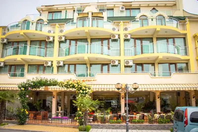 a large yellow building with a lot of windows at Hotel Energy in Kiten