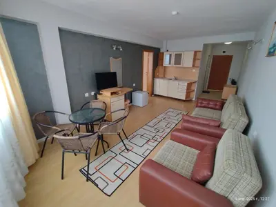 a living room with a couch and a table at Family Hotel Coral in Sozopol