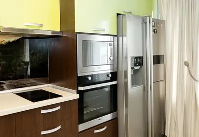 a kitchen with a refrigerator and a microwave at Modern 2-Level Apartment with Balcony in Varna by Flat Mаnager in Varna City