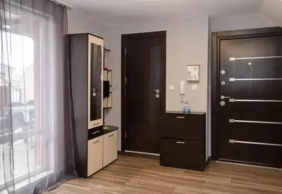 a room with a door and a dresser and a mirror at Modern 2-Level Apartment with Balcony in Varna by Flat Mаnager in Varna City
