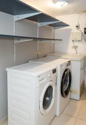 a white laundry room with a washer and dryer at Modern 2-Level Apartment with Balcony in Varna by Flat Mаnager in Varna City