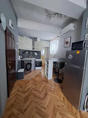 a kitchen with a refrigerator and a table in it at Varna city breaks 1 in Varna City