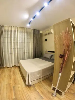 a bedroom with a bed and a vase of flowers at Salt Lake Studio in Pomorie