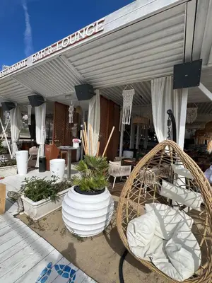 a patio with chairs and plants in front of a building at Apartmány Bulharsko Sveti Vlas - Garden of Eden in Sveti Vlas