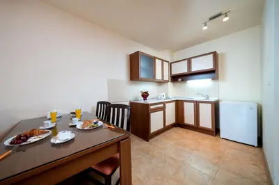 a kitchen with a table with food on it at Aurelia Beach Complex in Ravda
