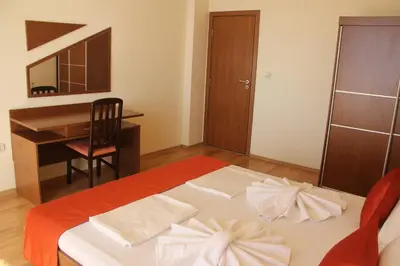 a bedroom with a bed with a desk and a desk at Aurelia Beach Complex in Ravda