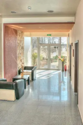 a lobby with couches and tables in a building at Dune Residence Apartments in Sunny Beach