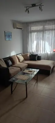 a living room with a couch and a glass table at Studio w kompleksie Ethara-3 in Sveti Vlas