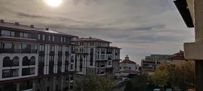 a view of buildings in a city with the sun at Studio w kompleksie Ethara-3 in Sveti Vlas