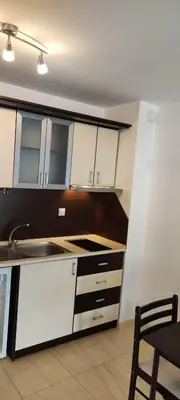a kitchen with white cabinets and a sink at Studio w kompleksie Ethara-3 in Sveti Vlas