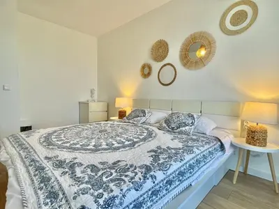 a bedroom with a blue and white bed with two lamps at Prestige Fort Aparthotel - Private apartment - BSR - 2 in Sveti Vlas
