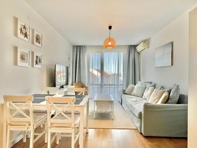 a living room with a couch and a table at Prestige Fort Aparthotel - Private apartment - BSR - 2 in Sveti Vlas